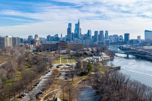 The Philadelphia skyline sits behind a view of the Schuylkill River and the Philadelphia Museum of Art.