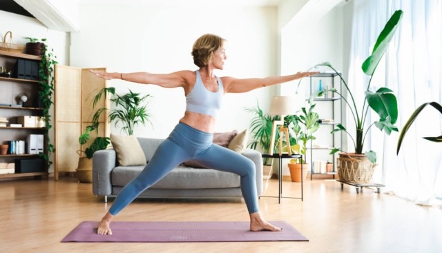 Renter doing yoga in her living room. 