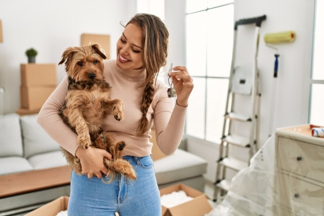 Tenant holds apartment keys with her emotional support animal.