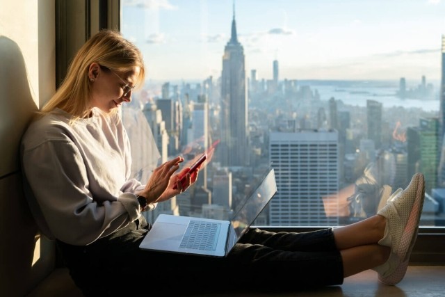 Tenant searches for rental listings while overlooking the New York City skyline. 