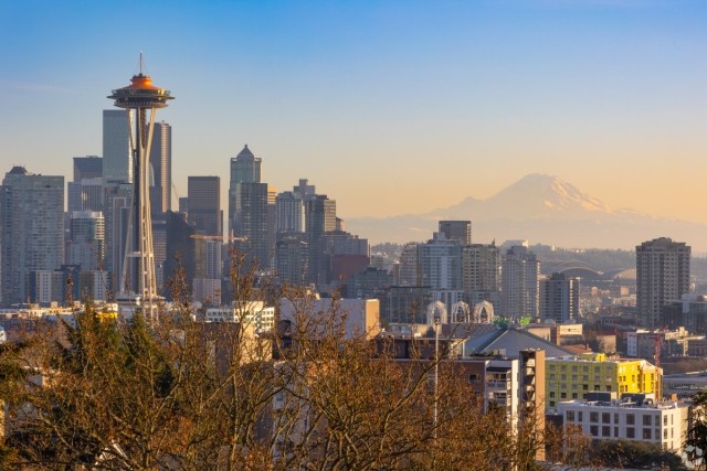 A view of the Space Needle from Belltown with Mount Rainier in the background.