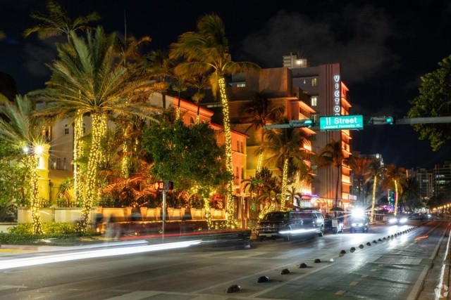 Night view of South Beach’s Ocean Drive with neon lights, art deco architecture, and palm trees wrapped in string lights — ideal for renters drawn to Miami’s vibrant nightlife and historic charm.