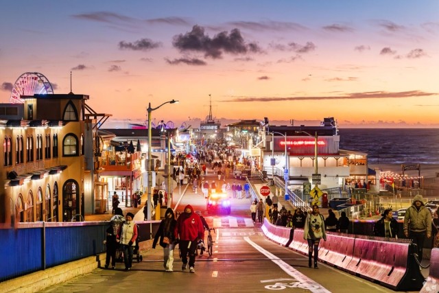Santa Monica Pier is filled with people well into the evening.