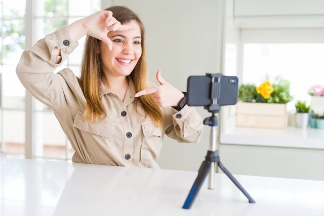 Renter posing in front of a tripod