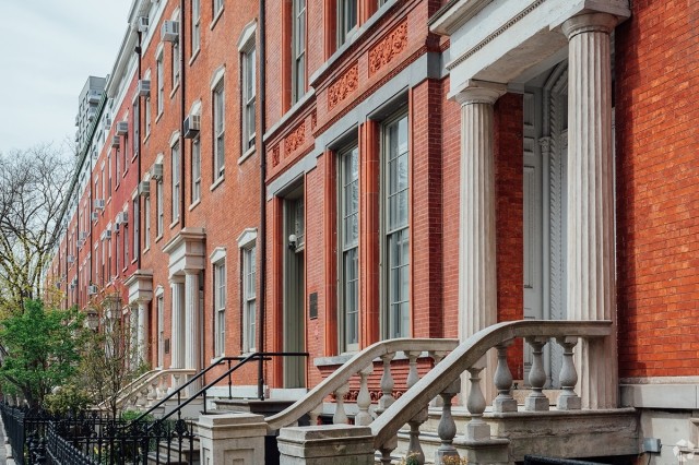 Beautiful brownstones with Greek revival cues line the Washington Square North block in the Greenwich Village neighborhood of Manhattan.