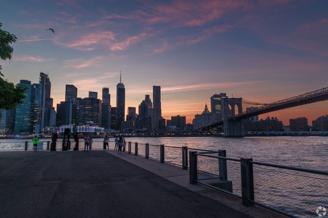 The New York City skyline is visible in Brooklyn. 