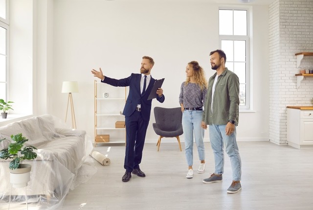 Apartment agent showing off a unit to a couple.