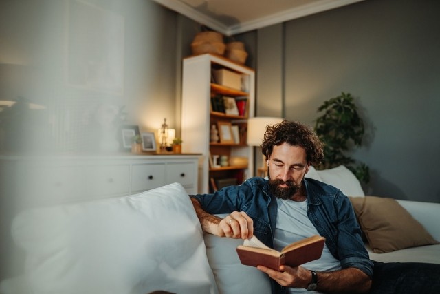 Man reading in his quiet apartment.