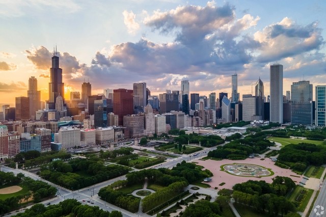 The Chicago skyline at sunset with Grant Park in the foreground.