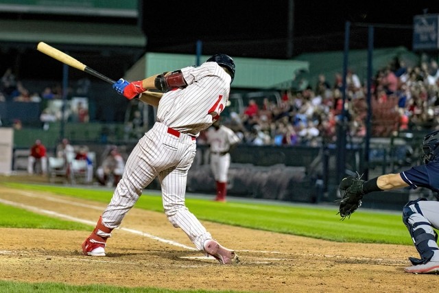 Baseball player swinging his bat.