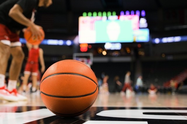 A basketball sitting on a court in a stadium.